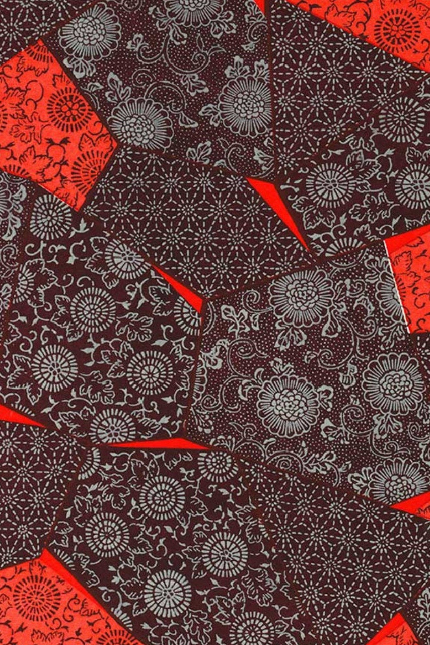 Patterned chiyogami paper with red and black geometric shapes on a dark background