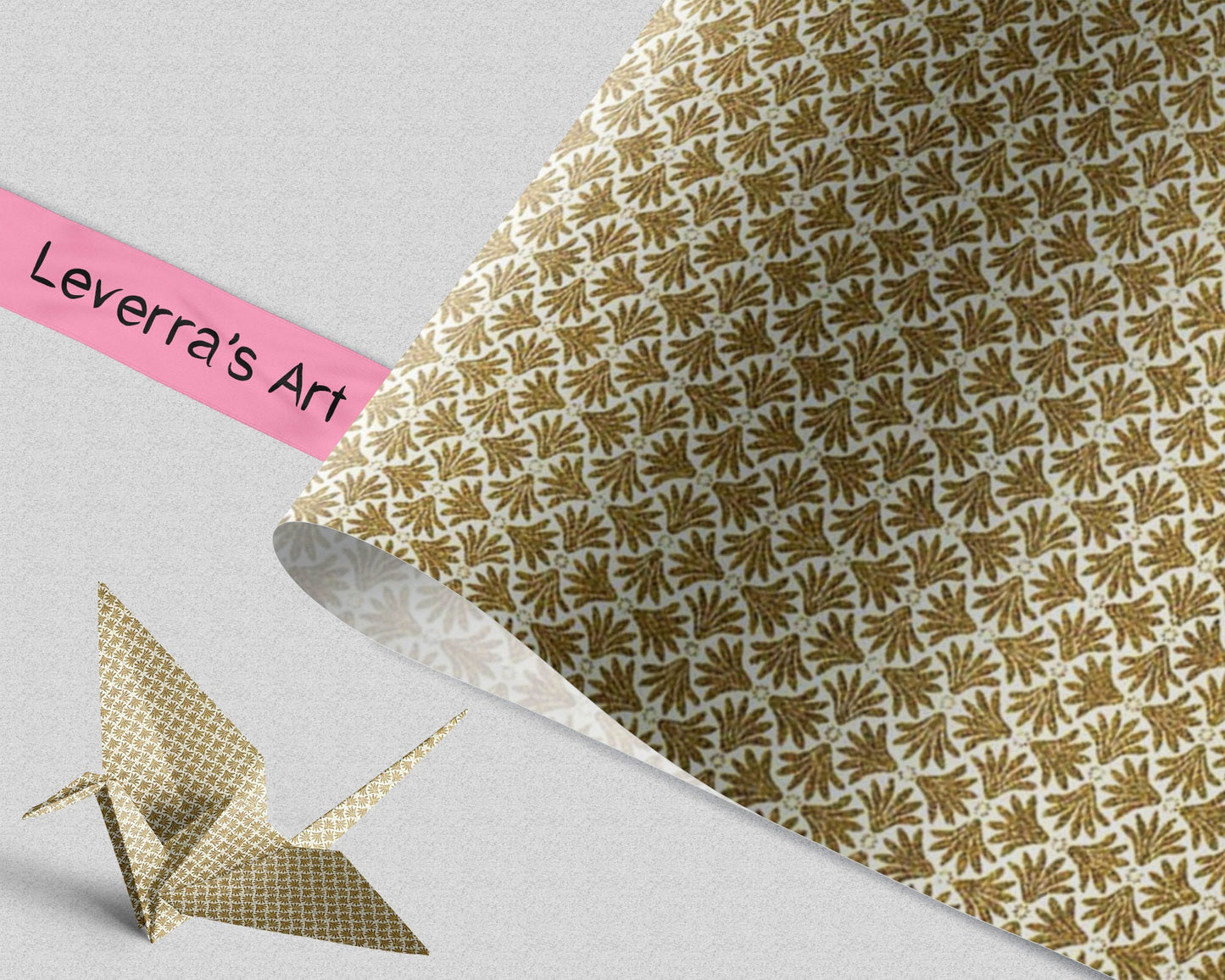 Gold patterned paper with a pink 'Leverra's Art' label and an origami crane on a light gray background.