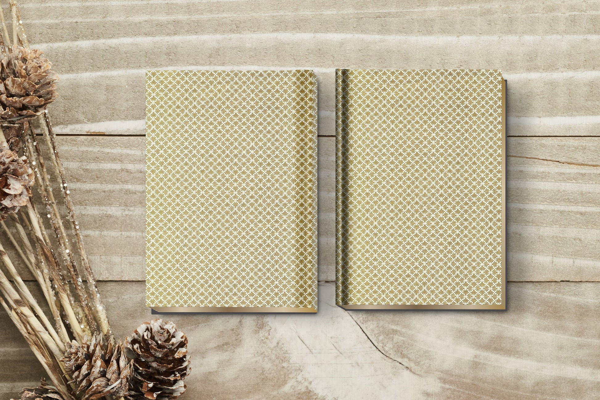Two patterned notebooks on a wooden surface with dried plants.