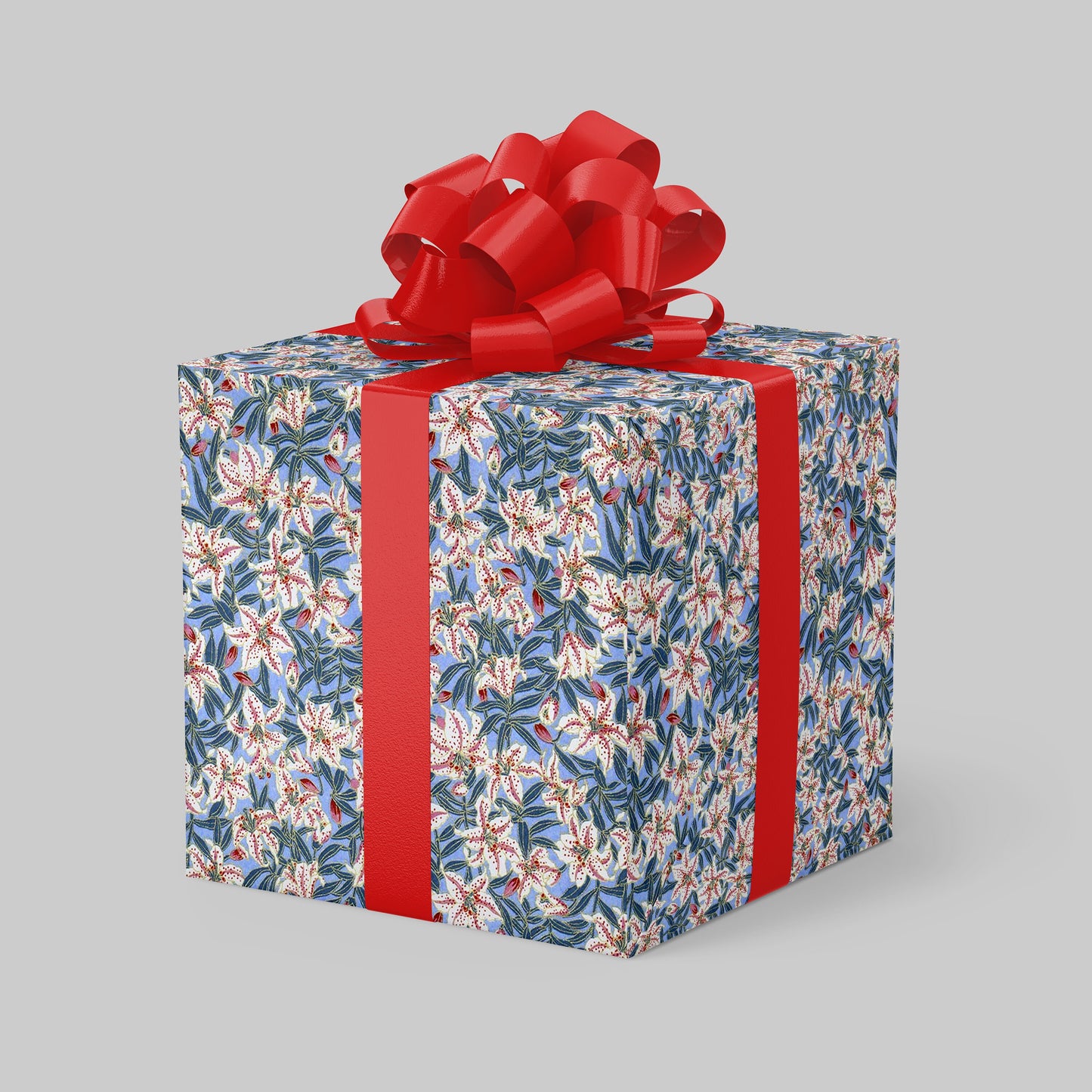 Gift box wrapped with chiyogami paper with floral pattern and red ribbon on a gray background