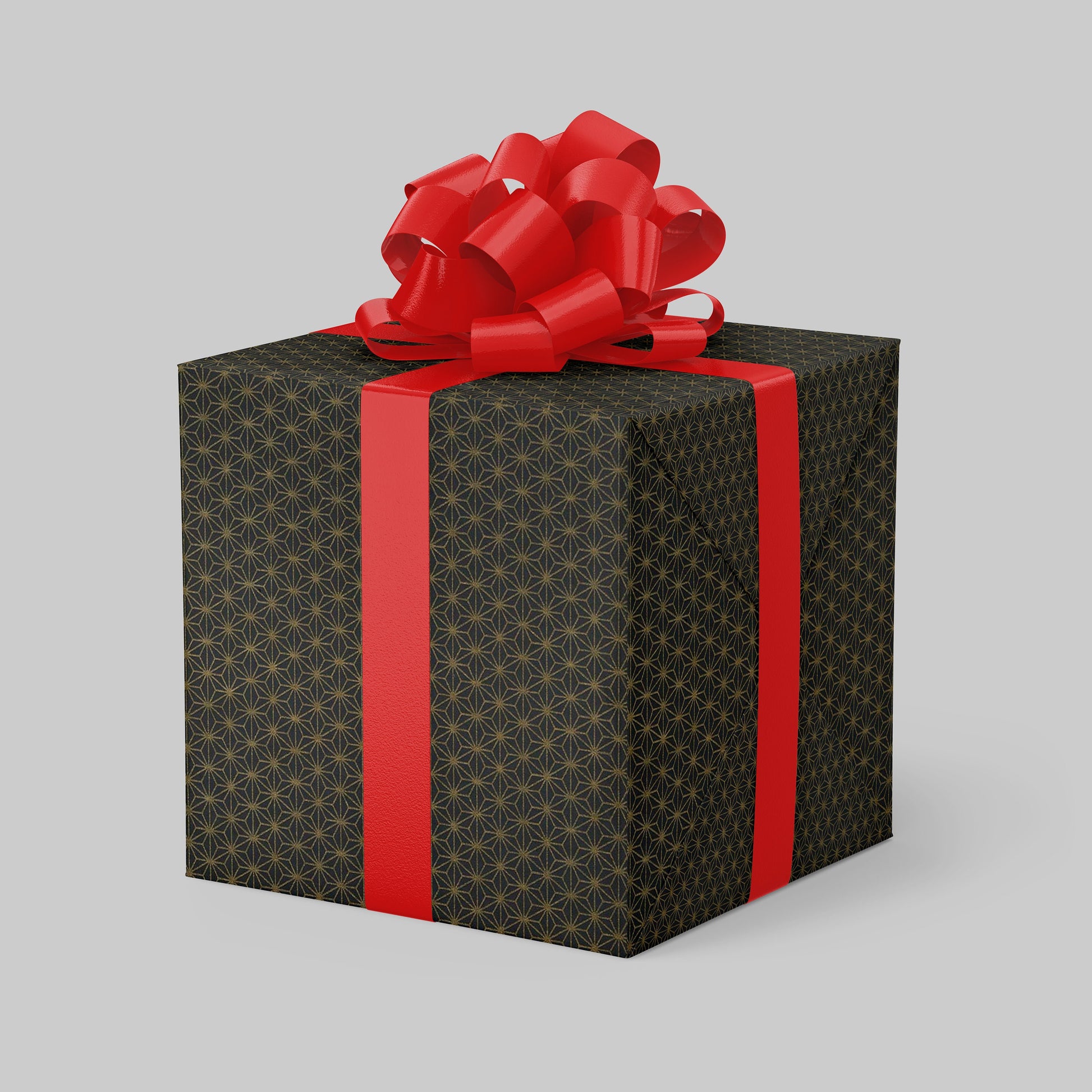 Gift box wrapped with chiyogami paper with black patterned paper and red ribbon on a gray background