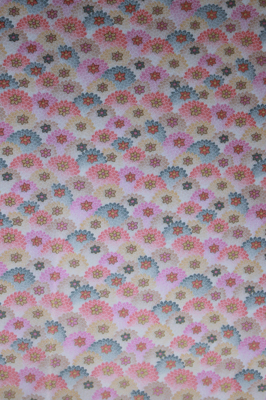 Floral patterned chiyogami paper with small flowers in various colors on a beige background