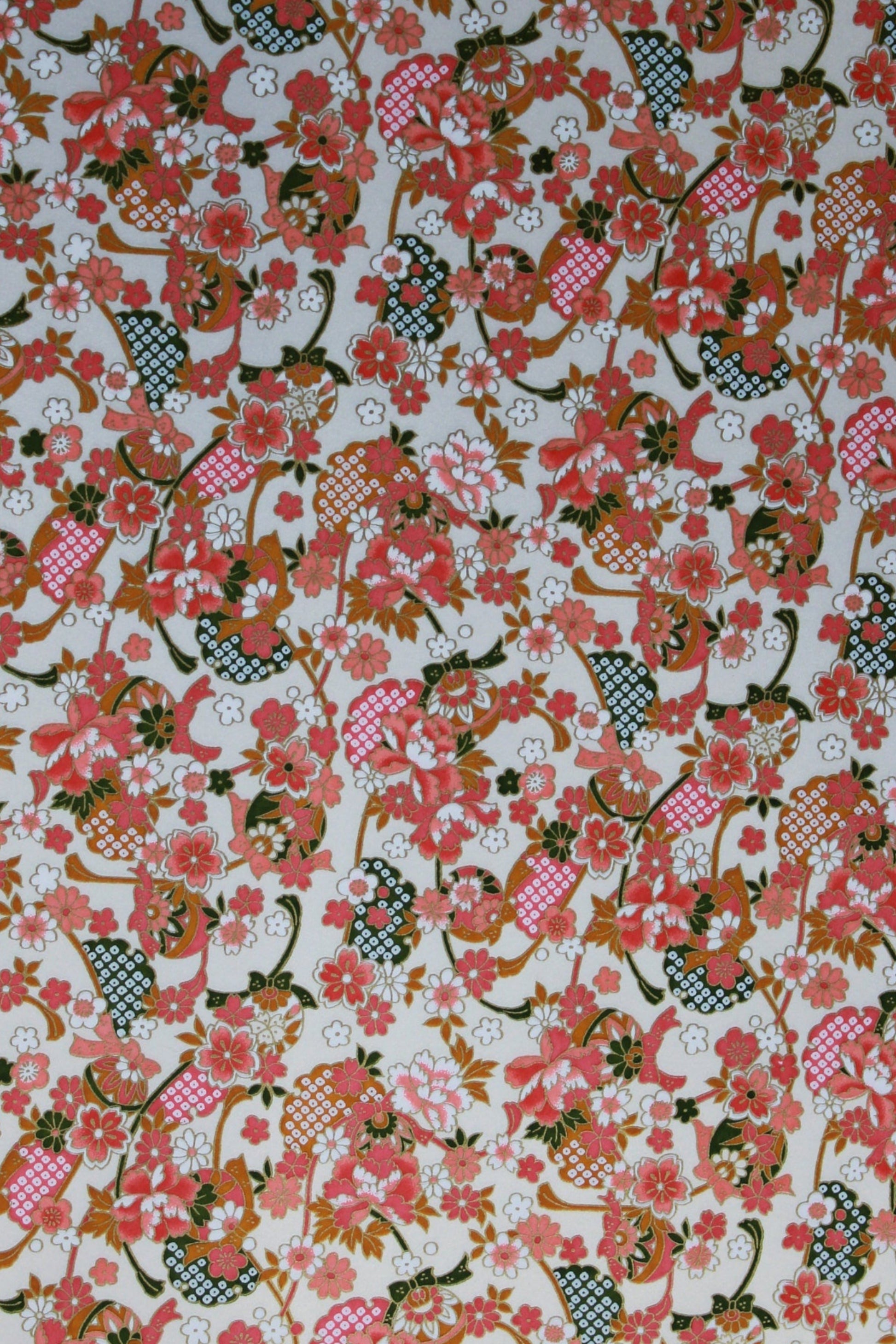 Floral patterned  chiyogami paper with pink, red, and green colors on a white background