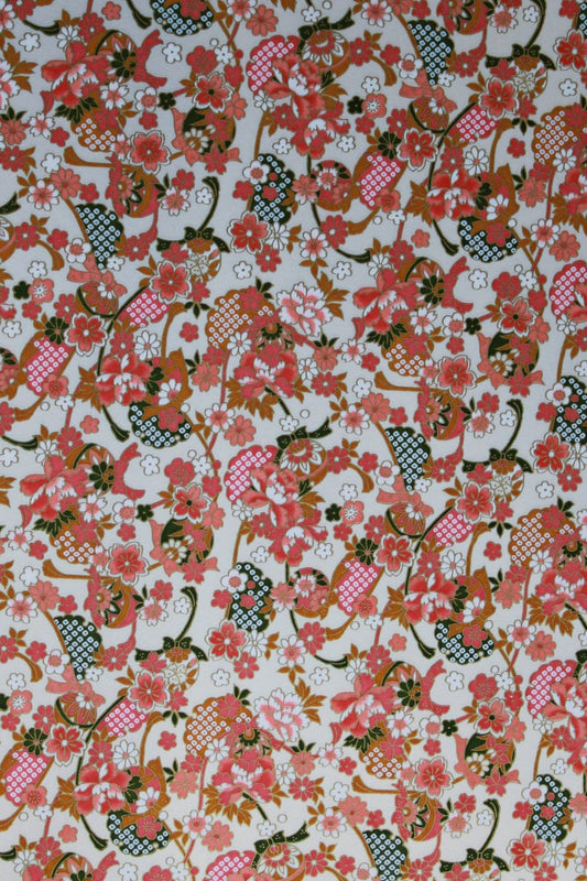 Floral patterned  chiyogami paper with pink, red, and green colors on a white background
