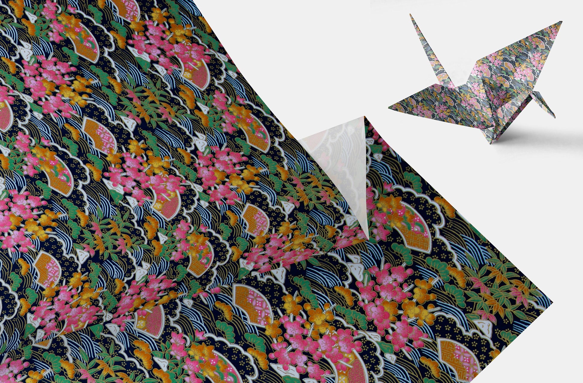 Decorative chiyogami paper with floral and wave pattern and a folded paper crane.
