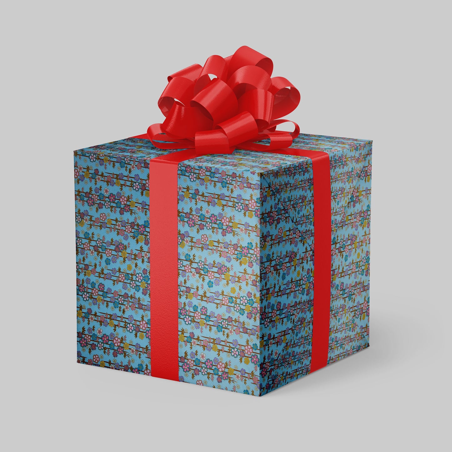 Gift box wrapped with chiyogami paper with colorful pattern and red ribbon on a gray background