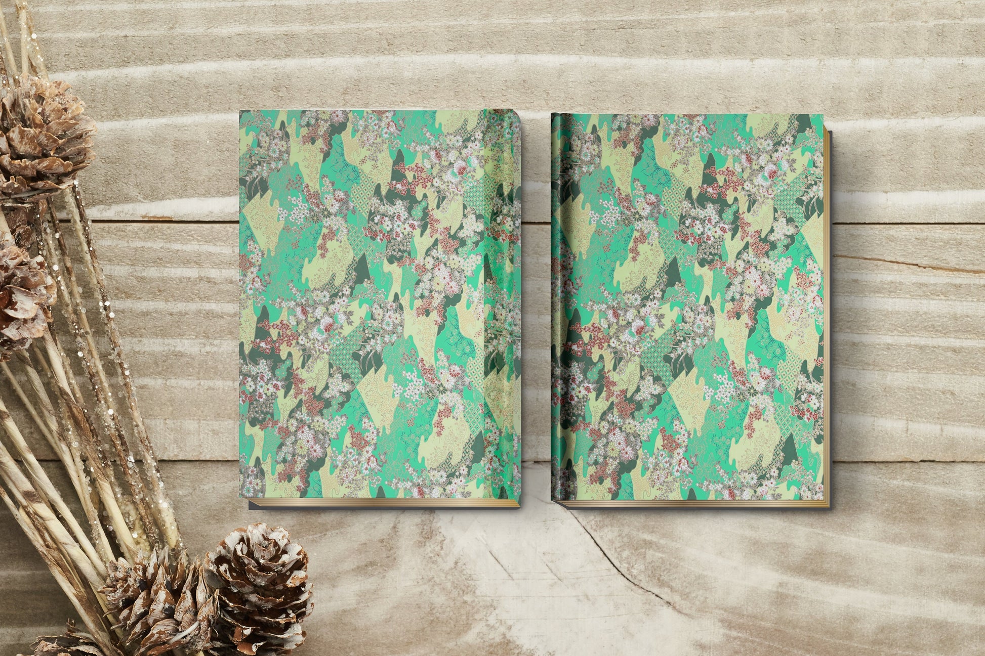 Two chiyogami paper floral-patterned notebooks on a wooden surface with decorative elements.