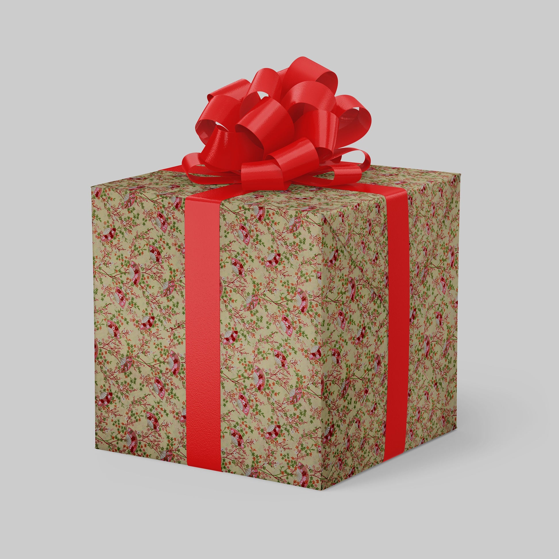 Gift box wrapped with chiyogami paper with floral pattern and red ribbon on a gray background