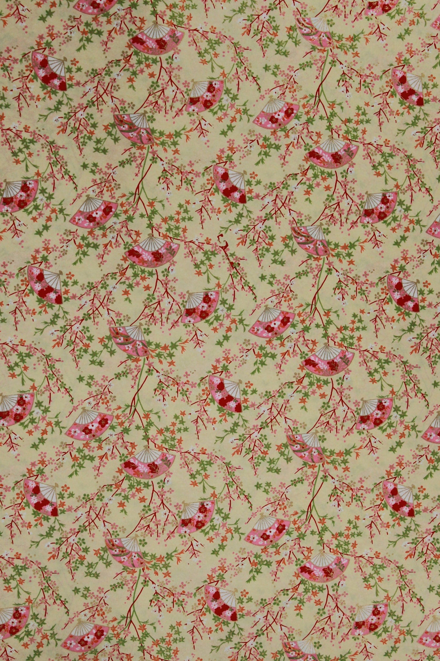 Floral patterned chiyogami paper  with red flowers and green leaves on a beige background
