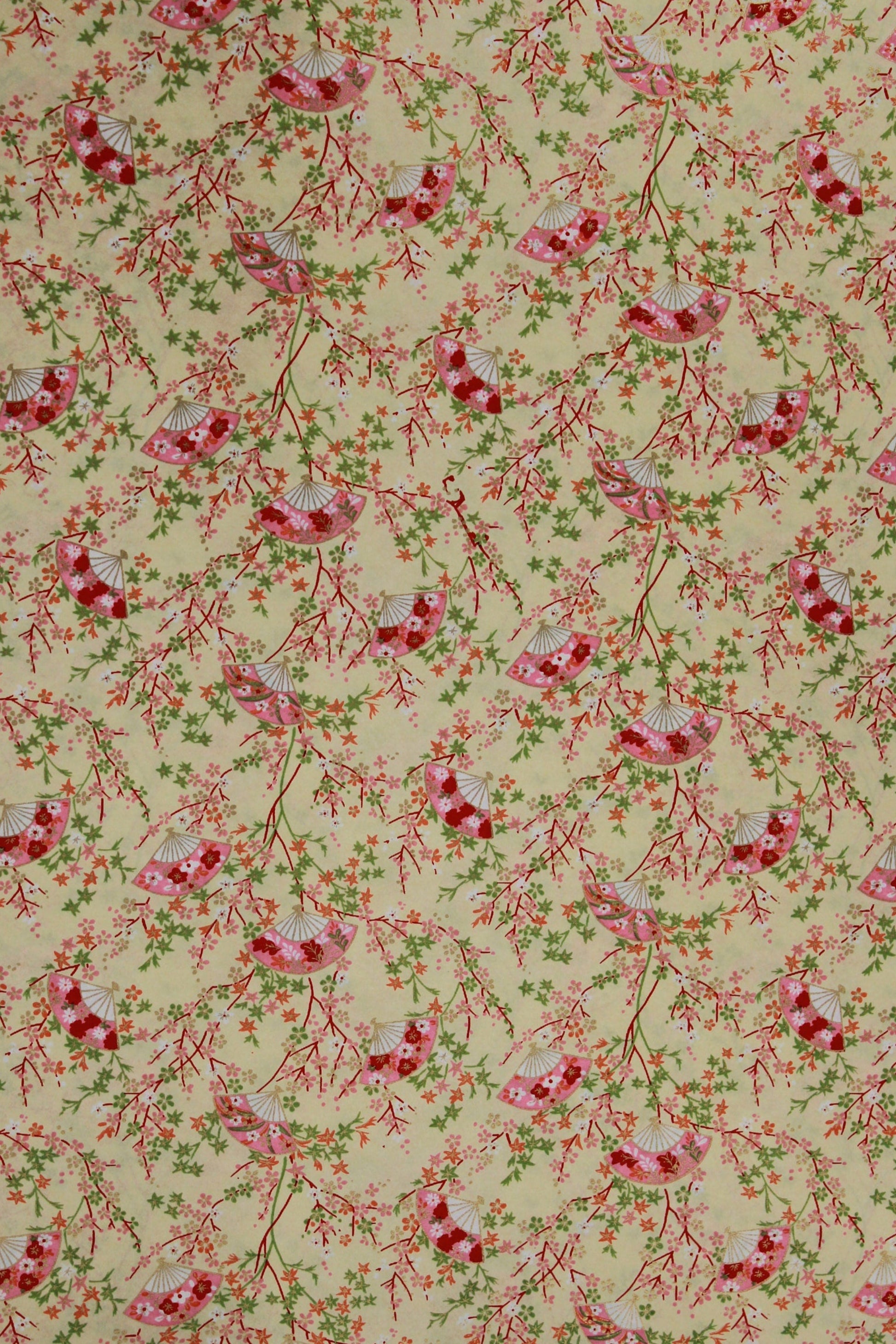 Floral patterned chiyogami paper  with red flowers and green leaves on a beige background