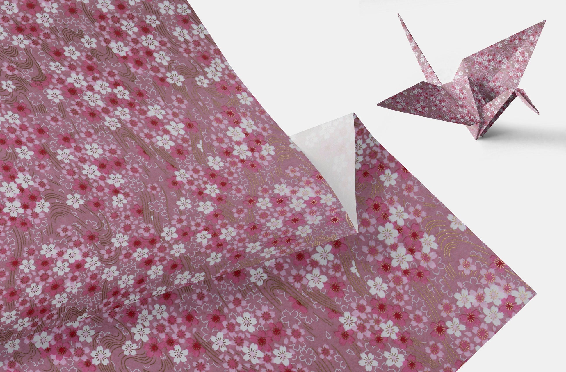 Floral-patterned chiyogami paper with a folded paper crane on a white background