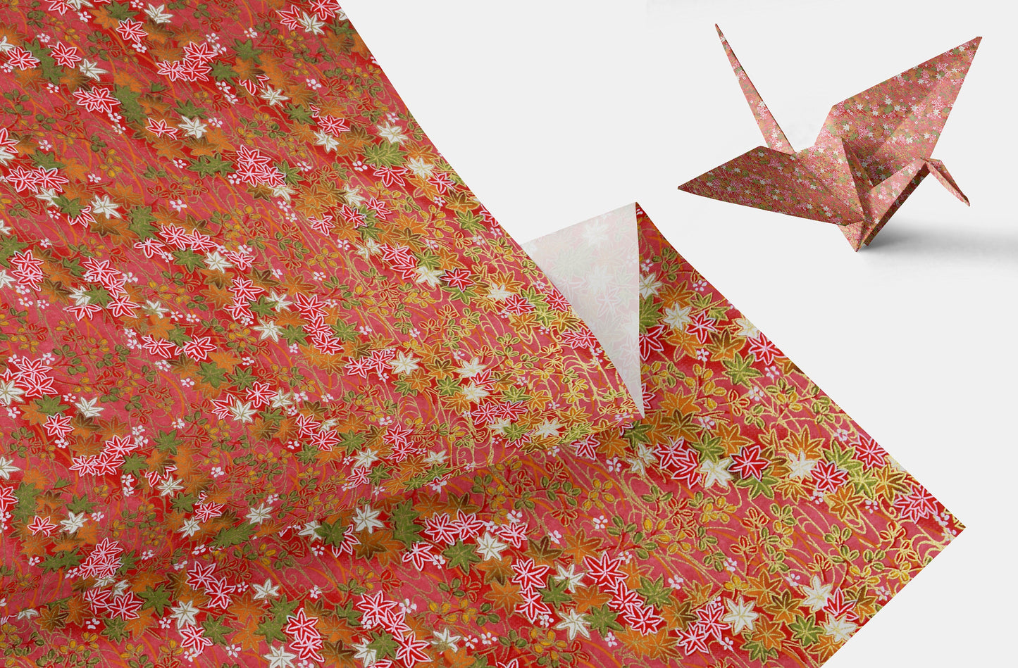 Floral-patterned paper with a folded paper crane on a white background