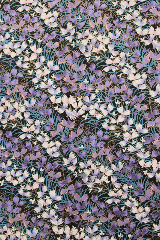 Pattern of small purple and white flowers on a fabric background