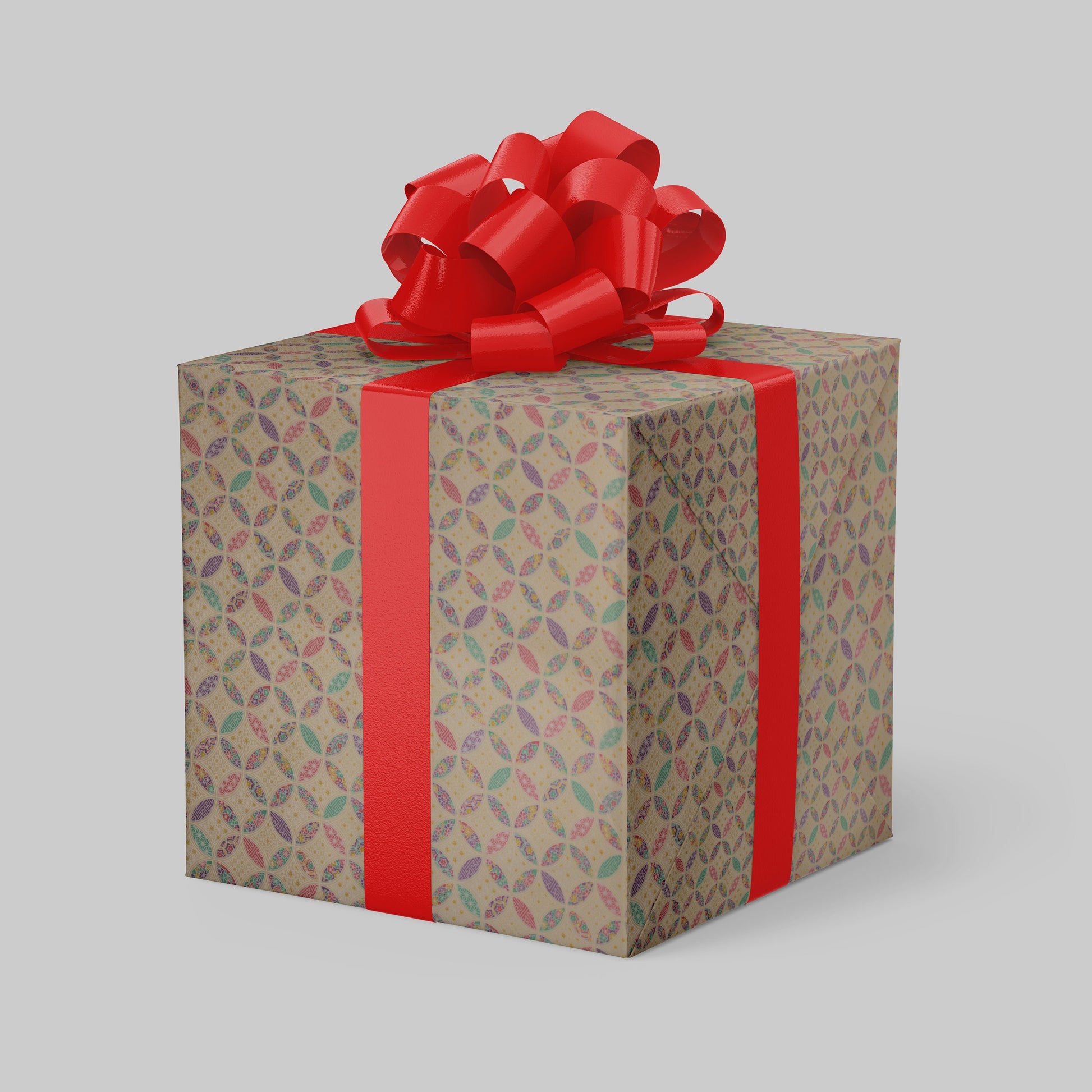 Gift box wrapped with chiyogami paper with patterned paper and red ribbon on a light gray background