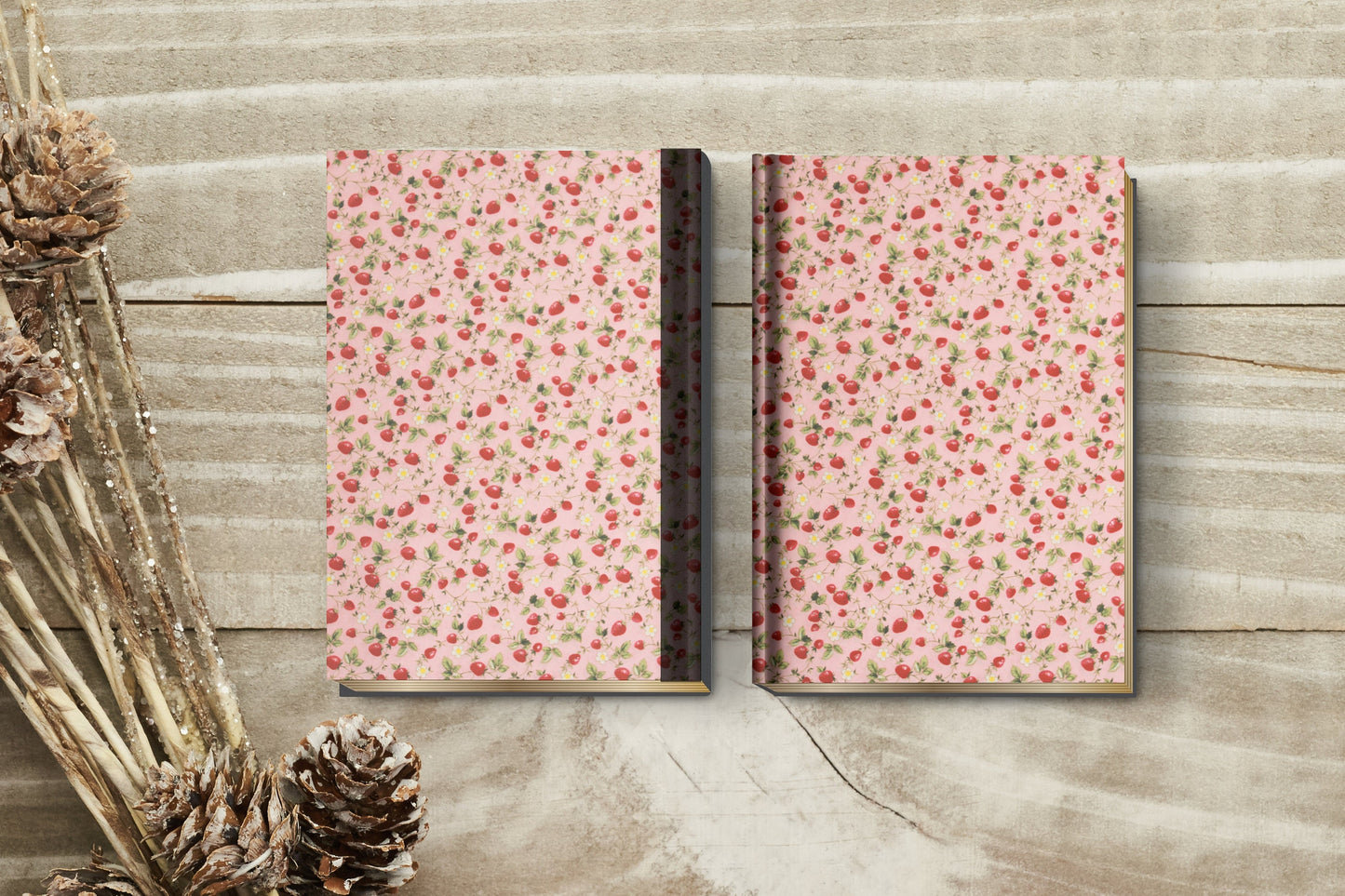 Two floral-patterned notebooks on a wooden surface with decorative elements.