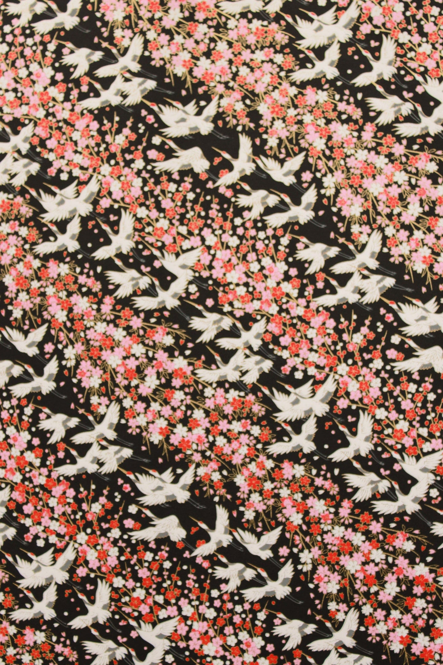 Pattern of white birds and pink flowers on a black background
