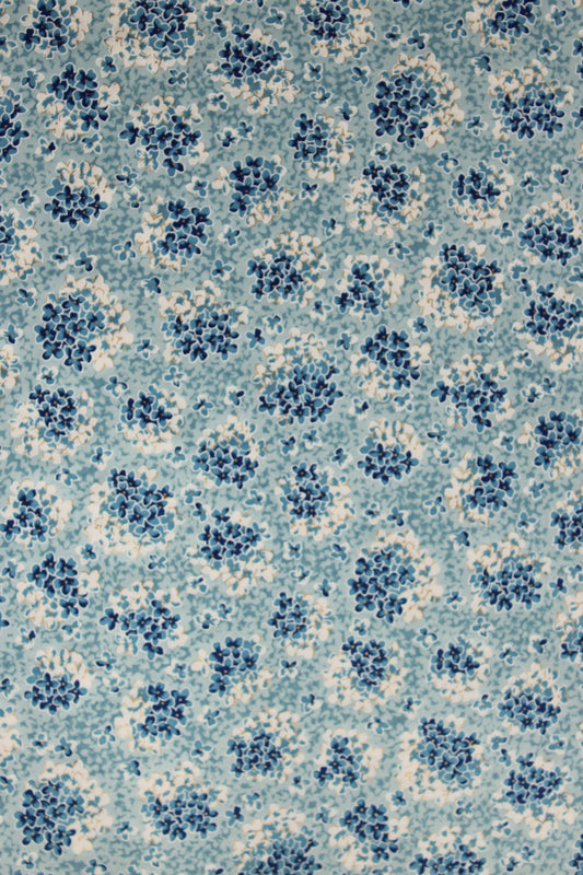 Patterned chiyogami paper with blue and white design on a blue background