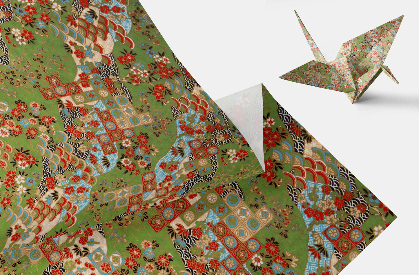 Decorative chiyogami paper with floral patterns and a folded paper crane on a light gray background.
