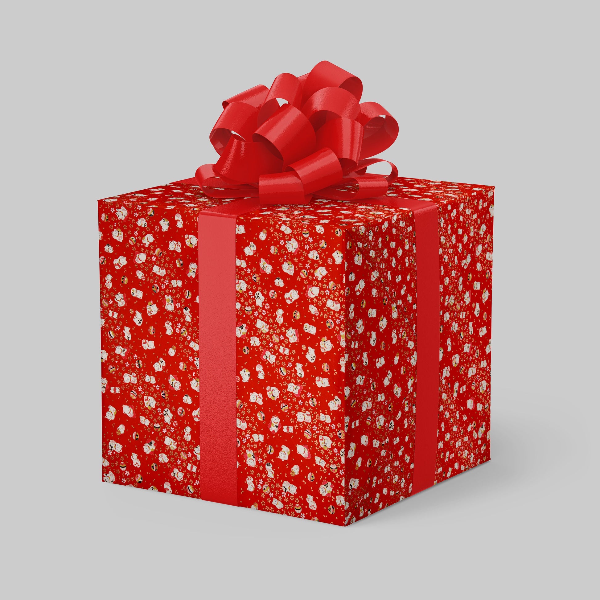 Red gift box with chiyogami paper pattern and a large red bow on a gray background