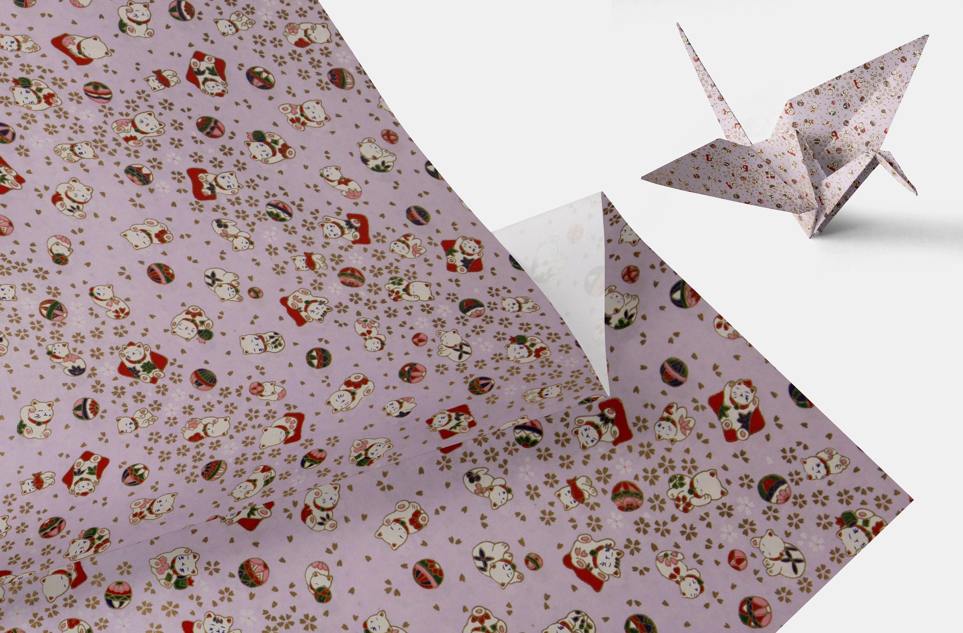 Floral patterned paper with a folded paper crane on a white background