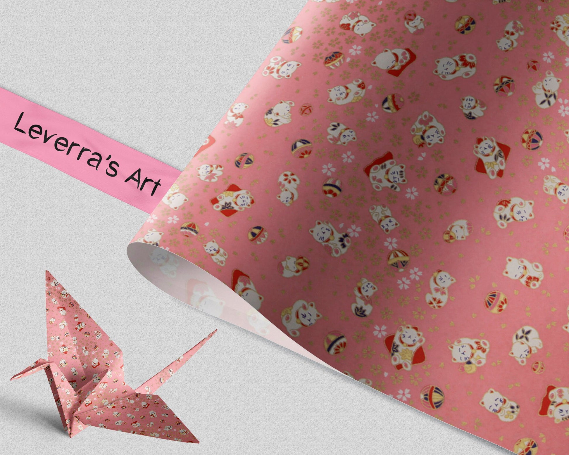 Pink patterned paper with cartoon characters and a folded paper crane on a light gray background, featuring 'Leverra's Art' branding.