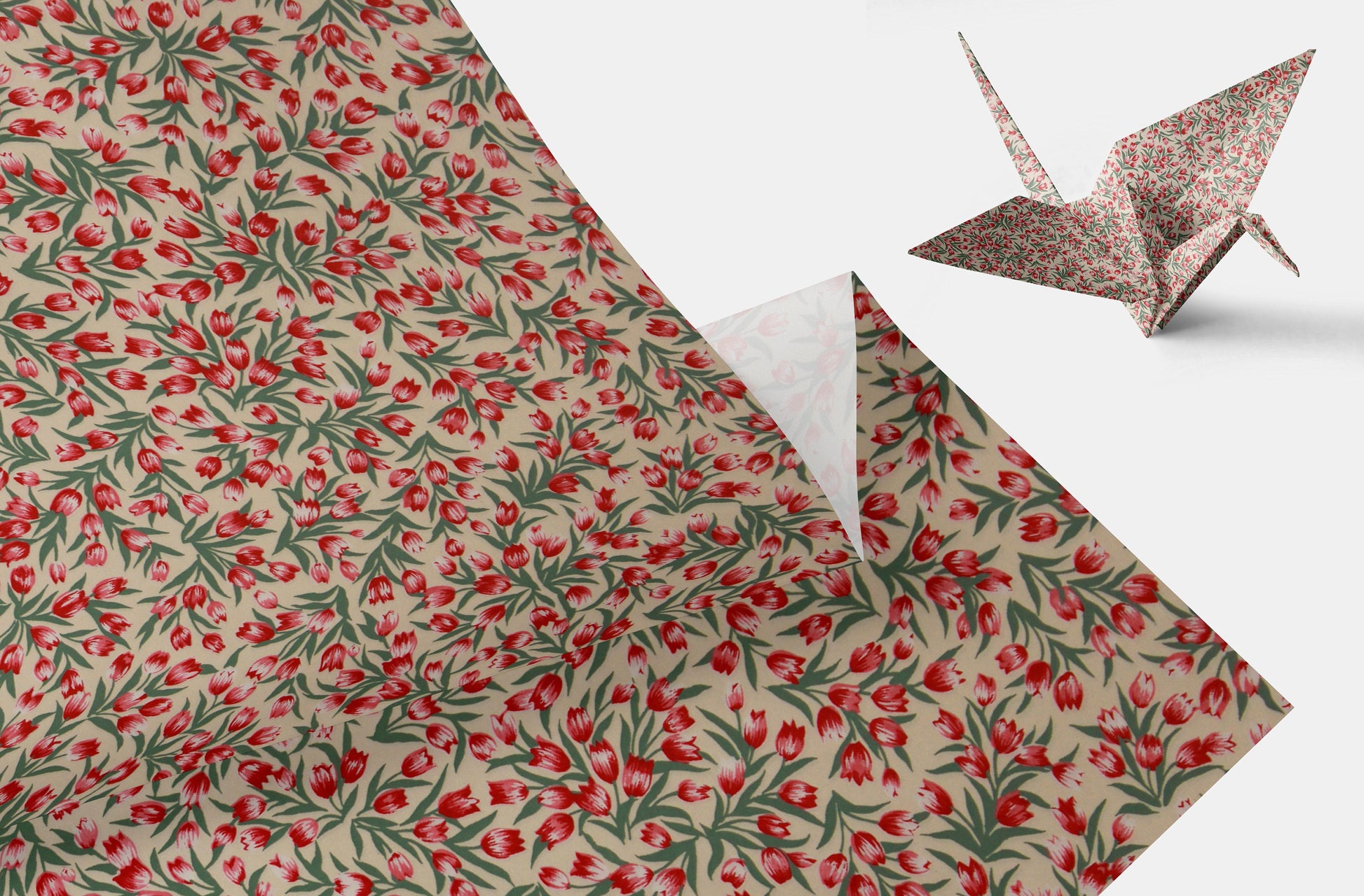 Floral-patterned paper with a folded origami crane on a white background