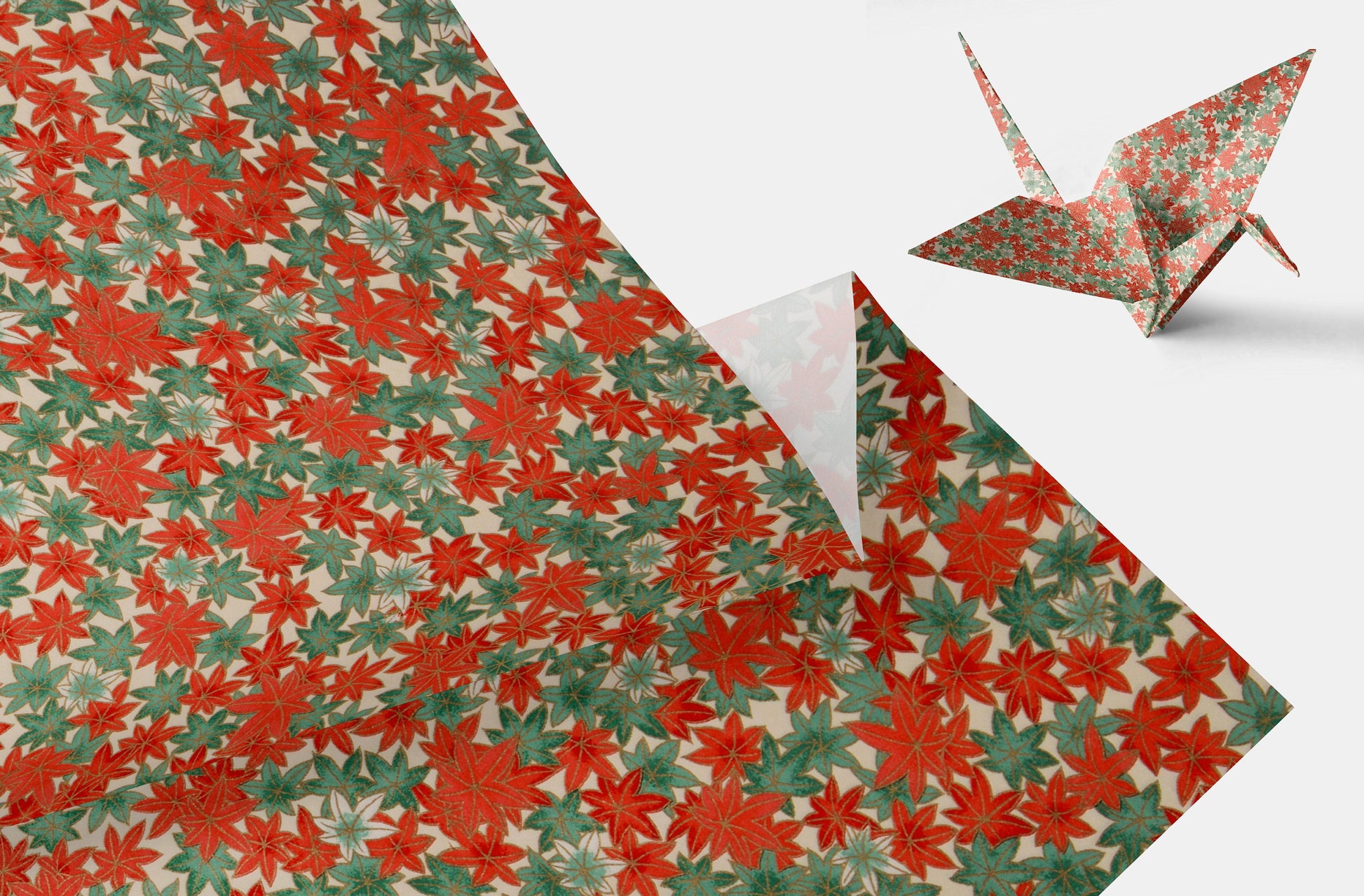 Red and green patterned chiyogami paper with a folded paper crane on a white background