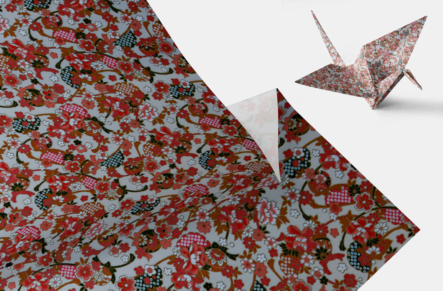 Floral and animal patterned paper with a folded paper crane on a white background