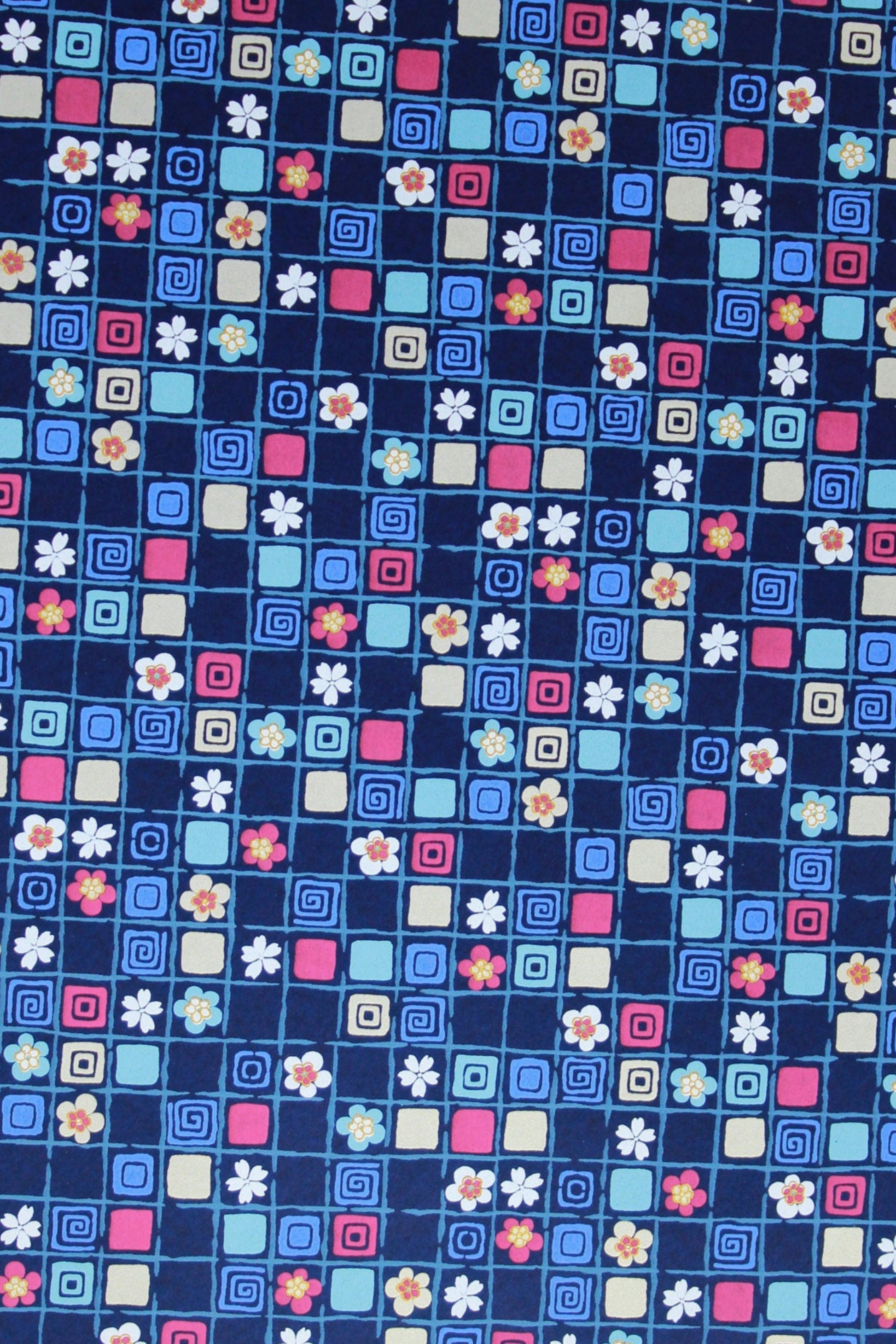 Patterned chiyogami paper with small squares and cross shapes on a blue background