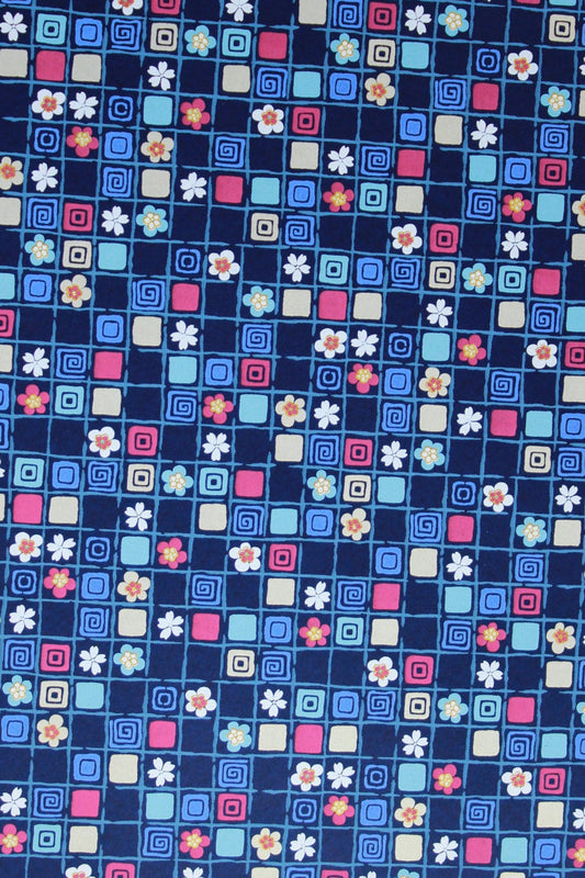Patterned chiyogami paper with small squares and cross shapes on a blue background