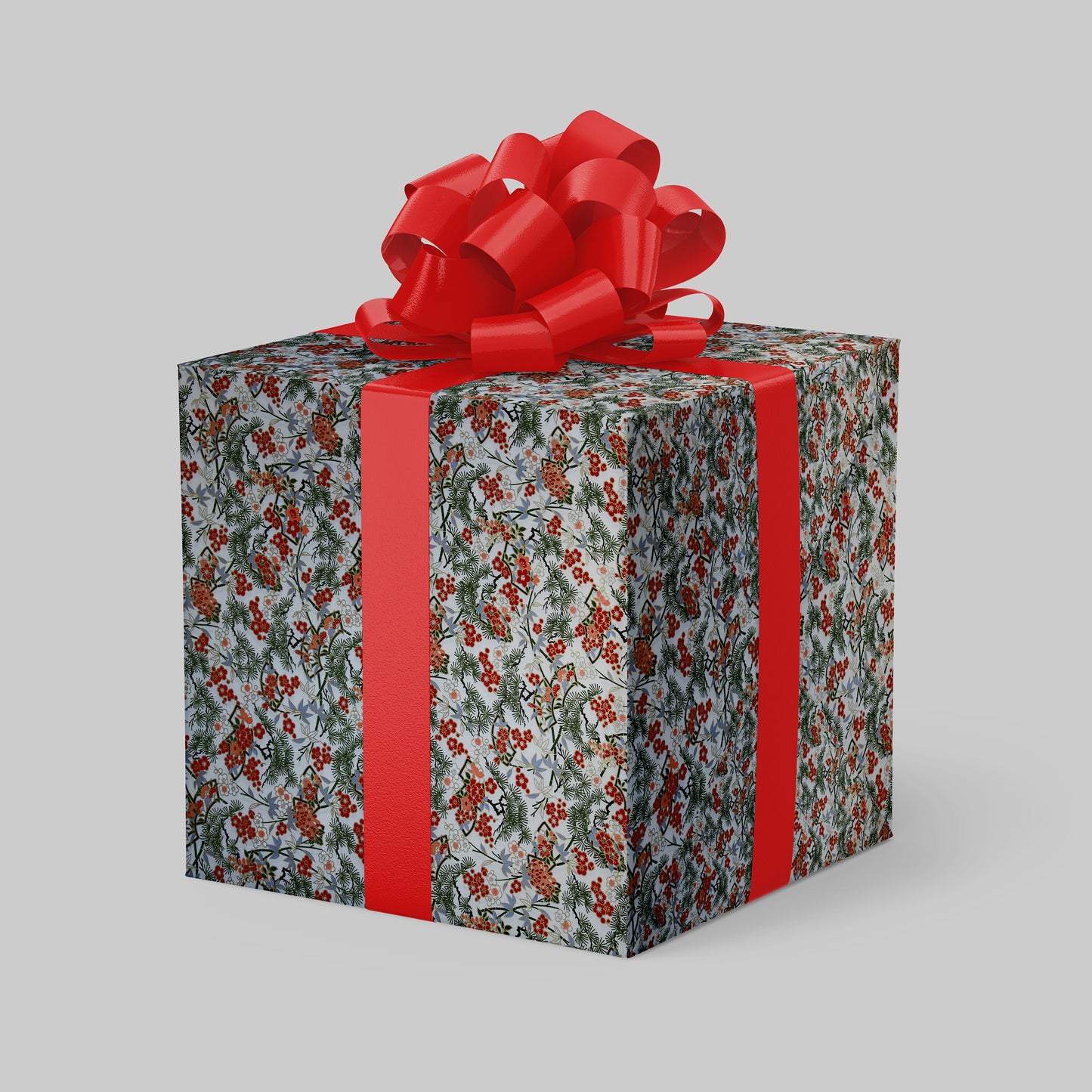 Gift box wrapped with chiyogami paper with floral pattern and red ribbon on a gray background