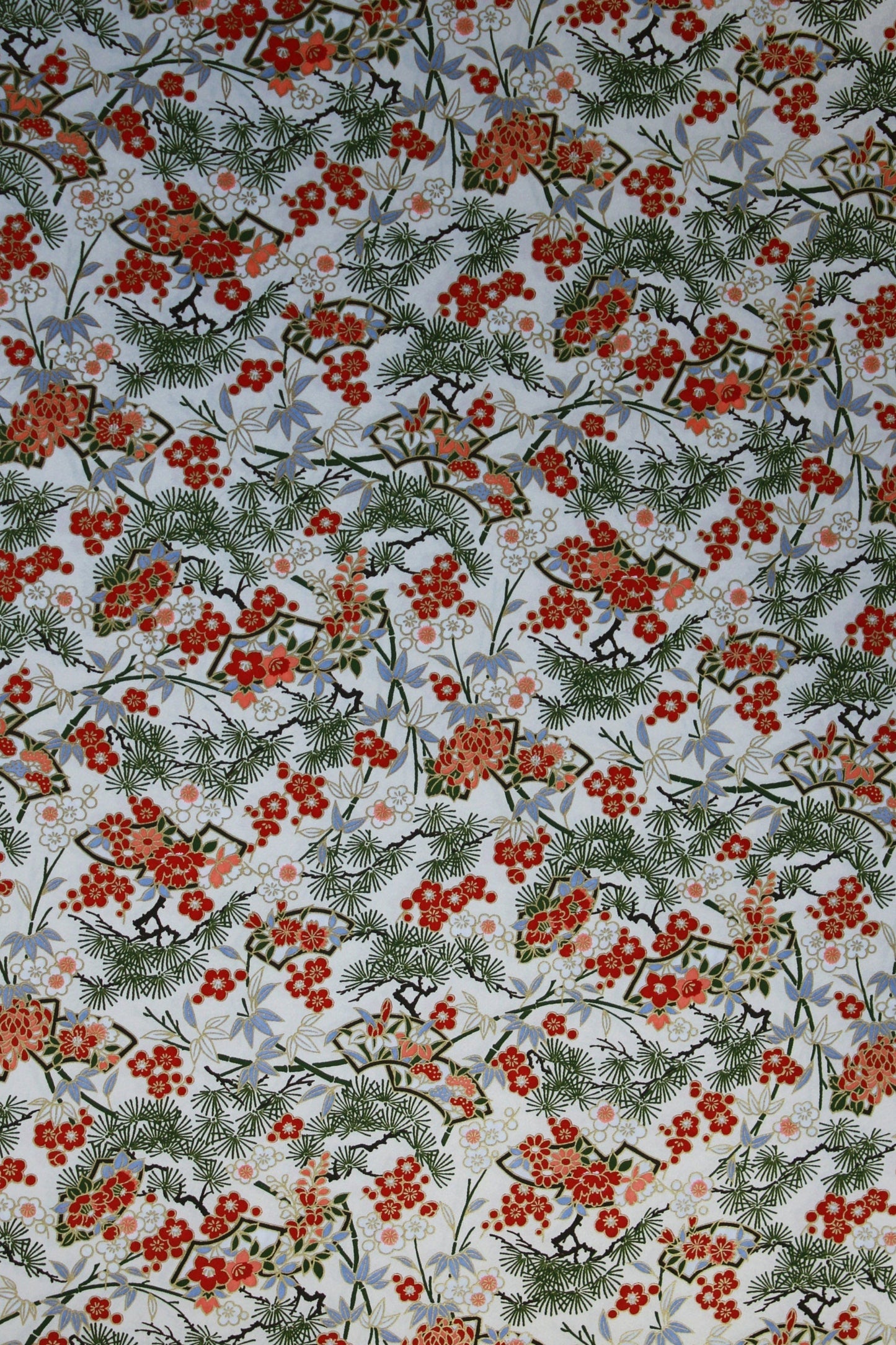 Festive chiyogami paper pattern with red berries and green leaves on a light background