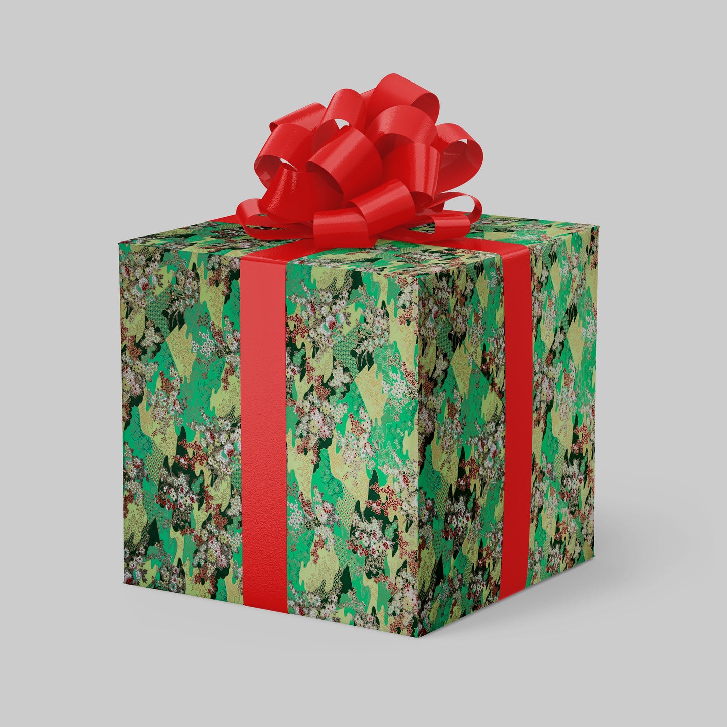 Gift box wrapped with chiyogami paper with floral pattern and red ribbon on a light gray background