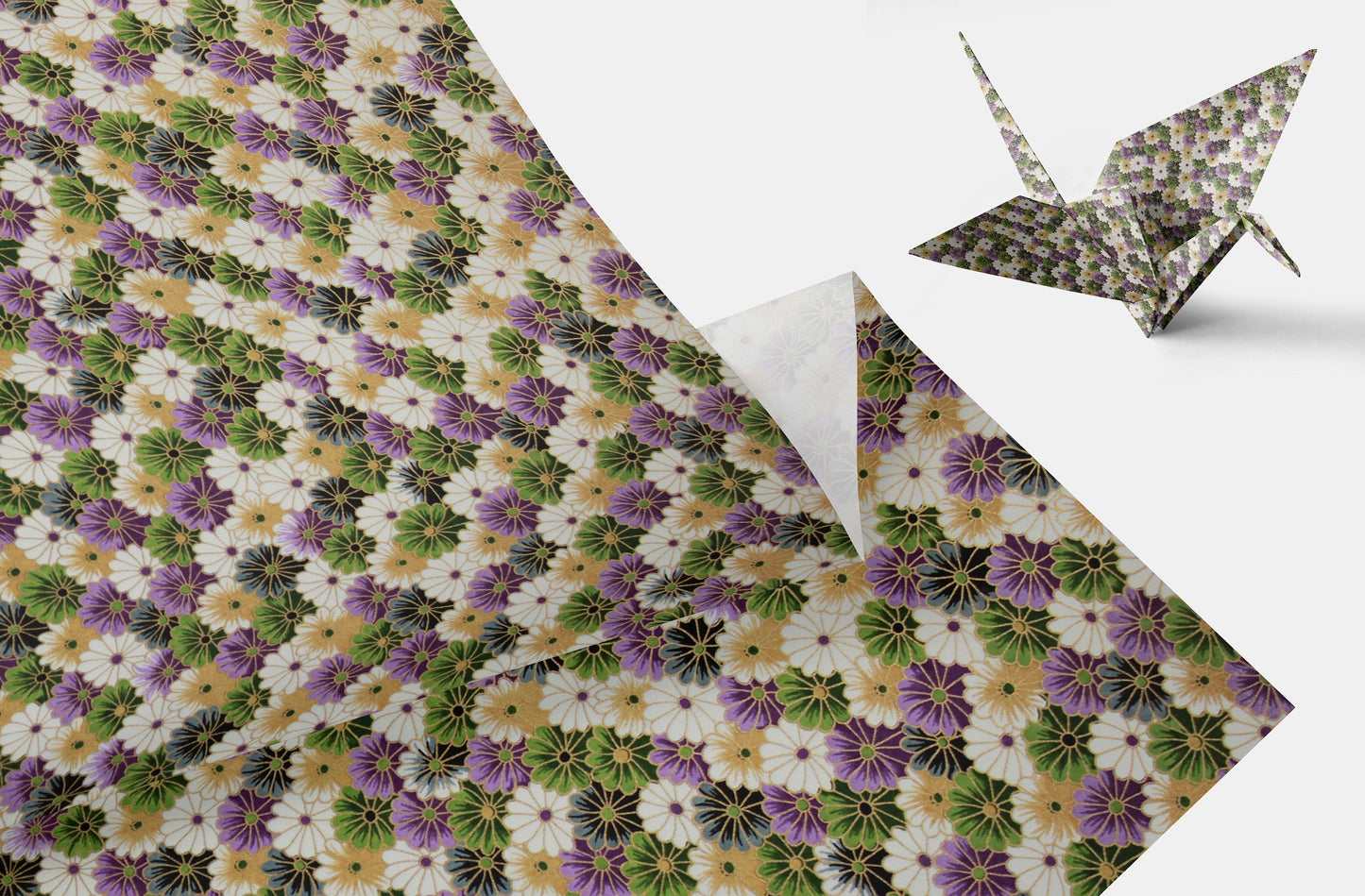 Floral patterned chiyogami paper with a folded paper crane on a white background