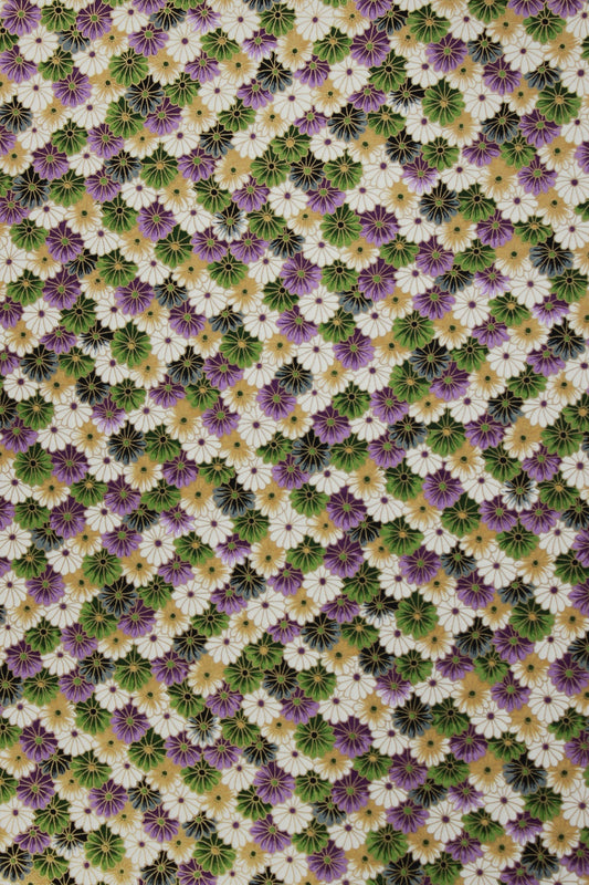 Chiyogami paper pattern of small flowers in green, purple, and white on a multicolored background