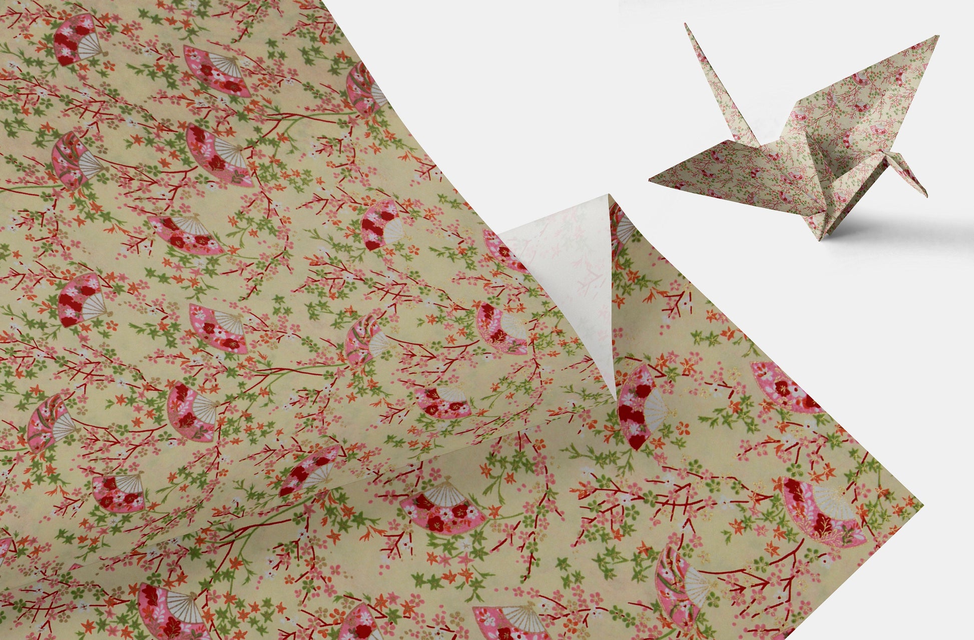 Floral-patterned chiyogami paper with a folded origami crane on a white background