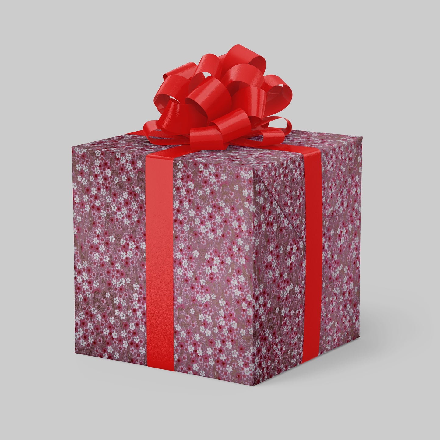 Gift box wrapped with chiyogami paper with floral pattern and red ribbon on a gray background