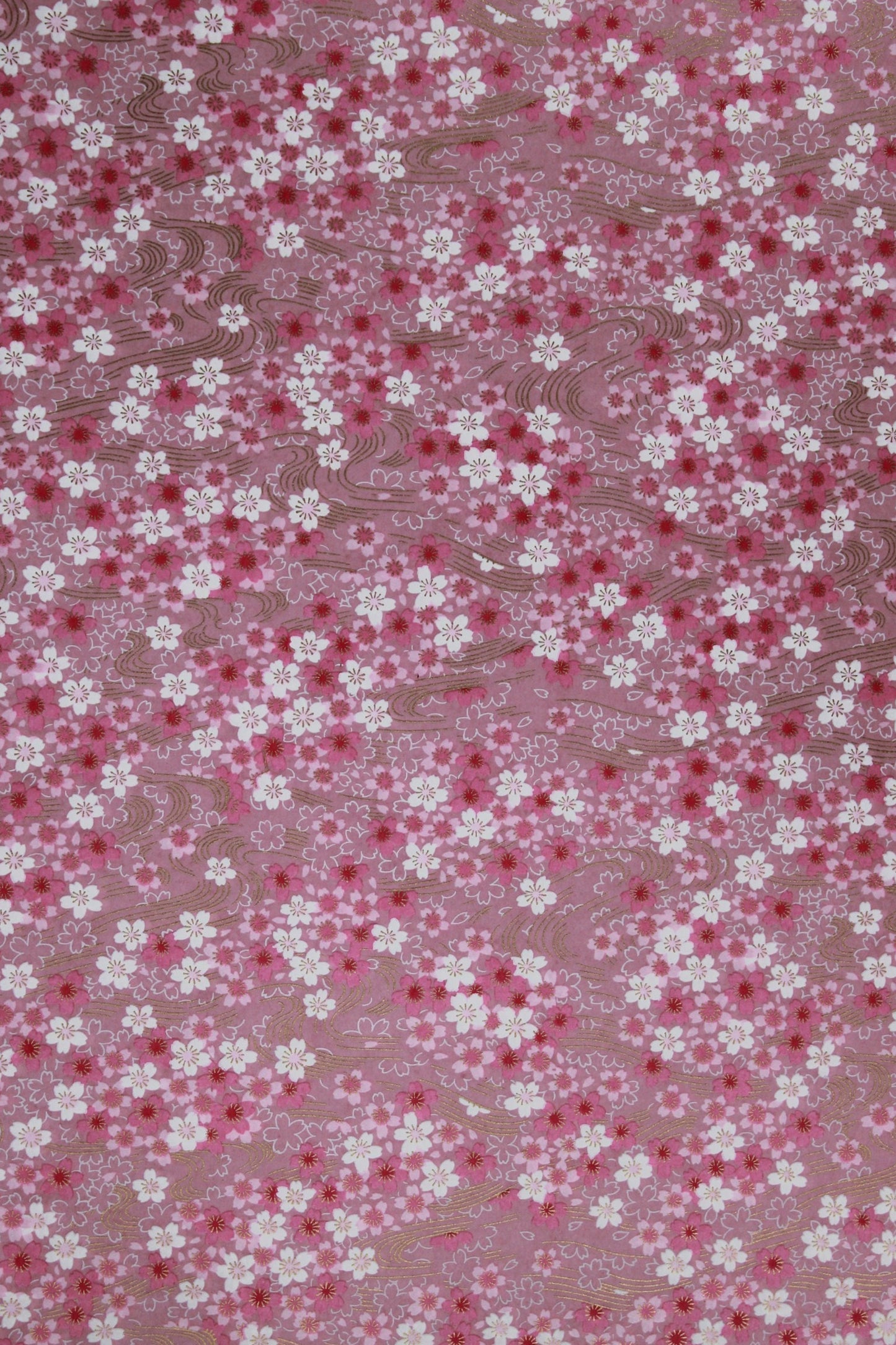 Floral patterned chiyogami paper with small white flowers on a pink background