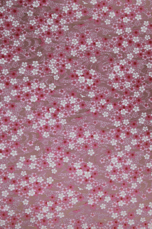 Floral patterned chiyogami paper with small white flowers on a pink background