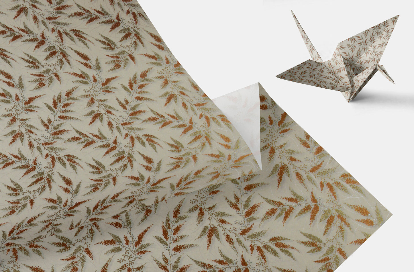 Patterned chiyogami paper with a floral design and a folded paper crane on a white background