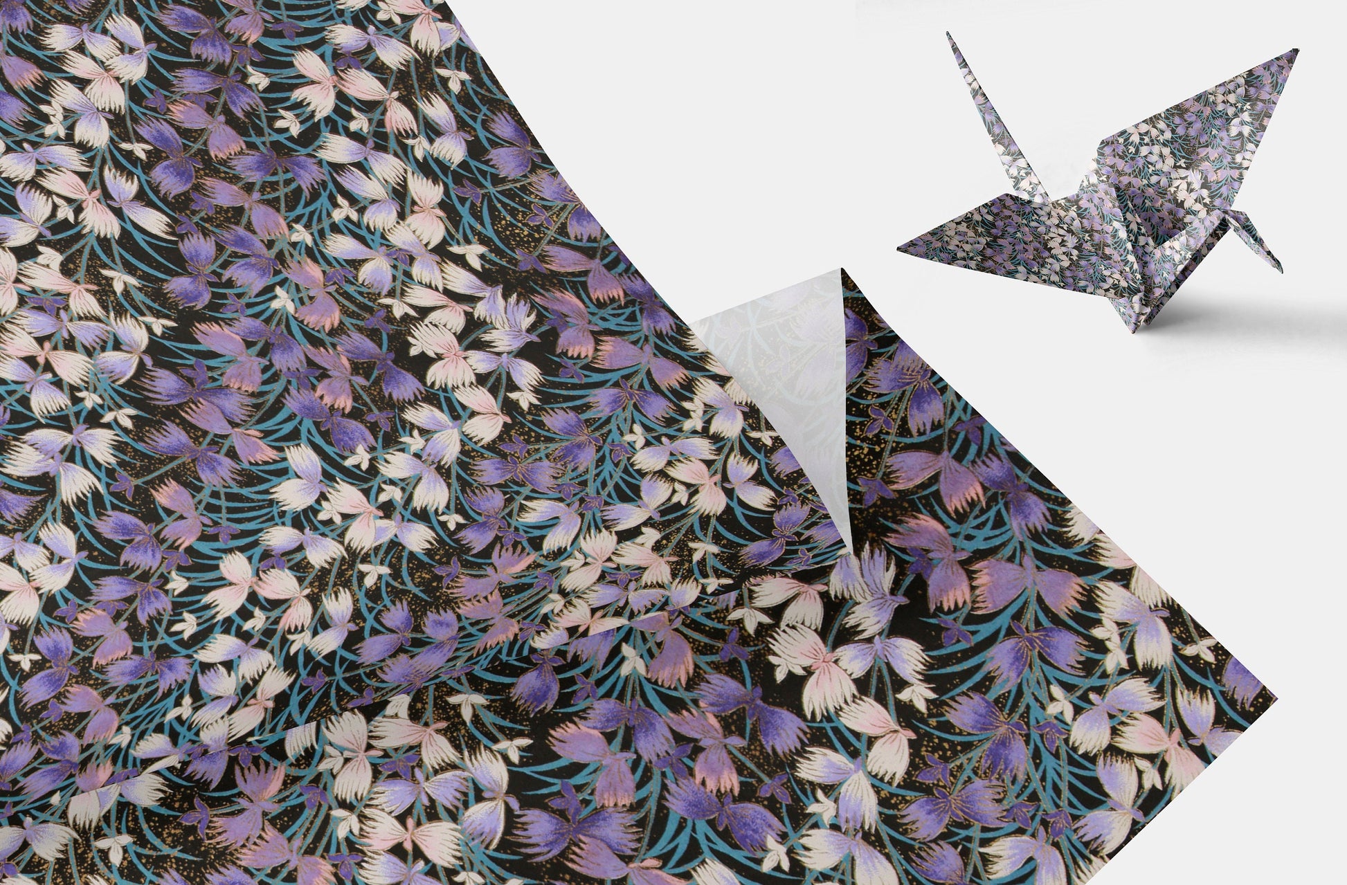 Floral patterned paper with a folded paper crane on a white background
