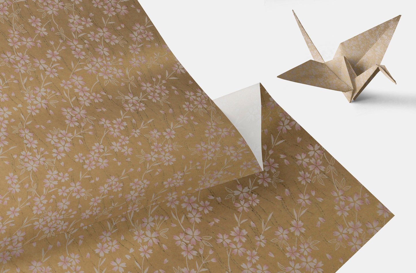 Floral-patterned chiyogami paper with an origami crane on a white background