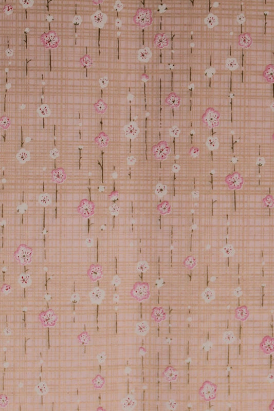 Chiyogami paper with a subtle pattern on a light pink background