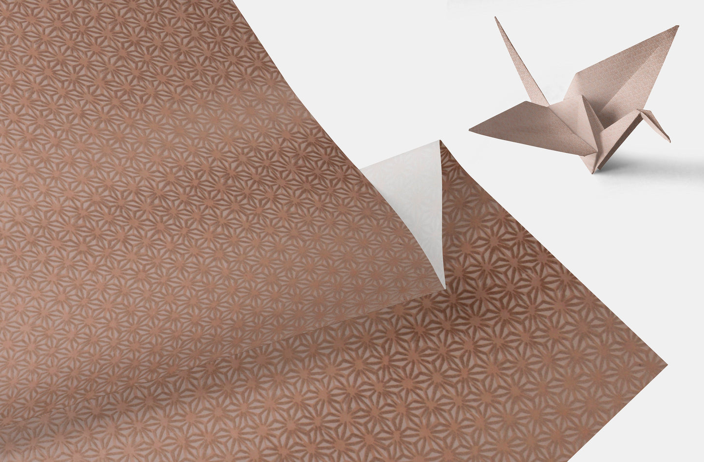 Brown patterned chiyogami paper with a folded paper crane on a white background