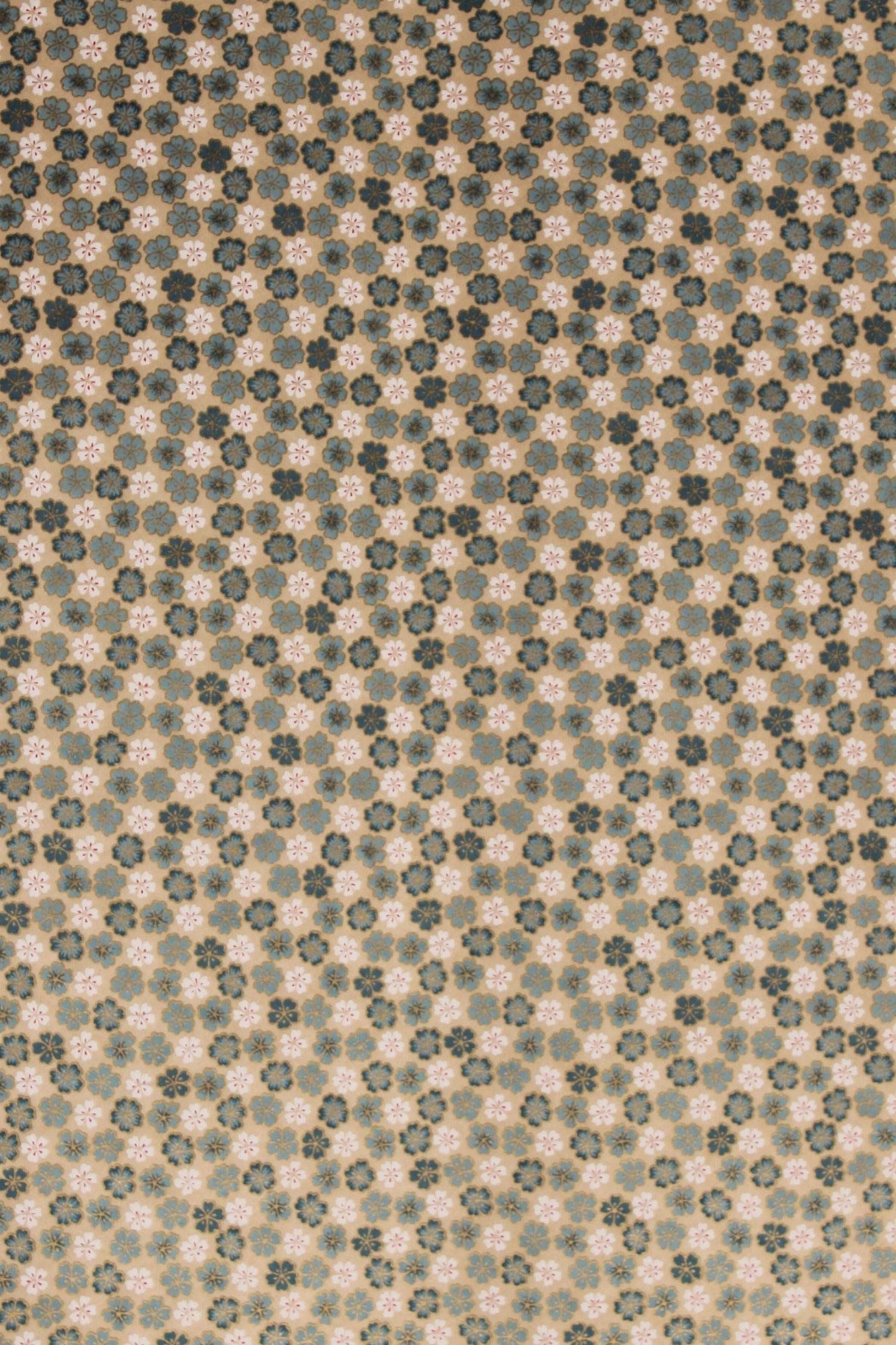 Textured chiyogami paper with a subtle floral pattern on a beige background