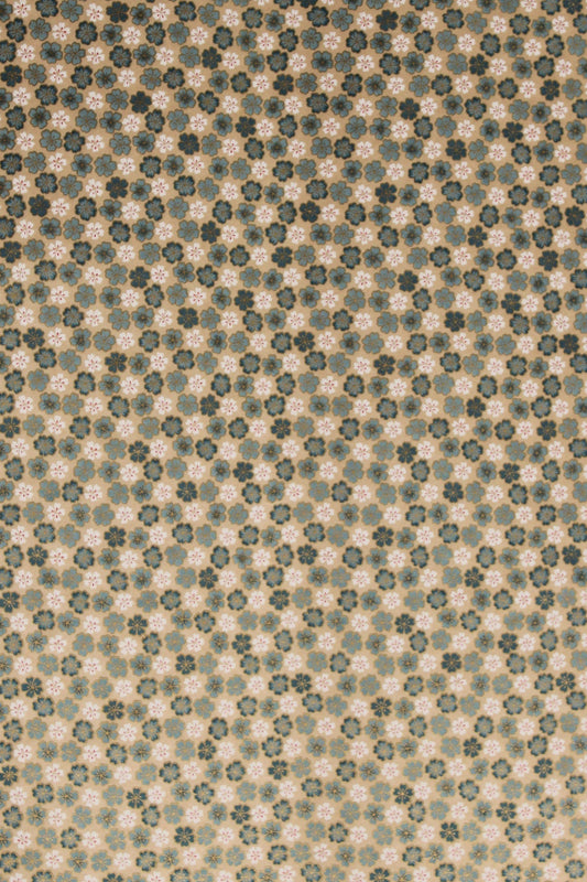Textured chiyogami paper with a subtle floral pattern on a beige background