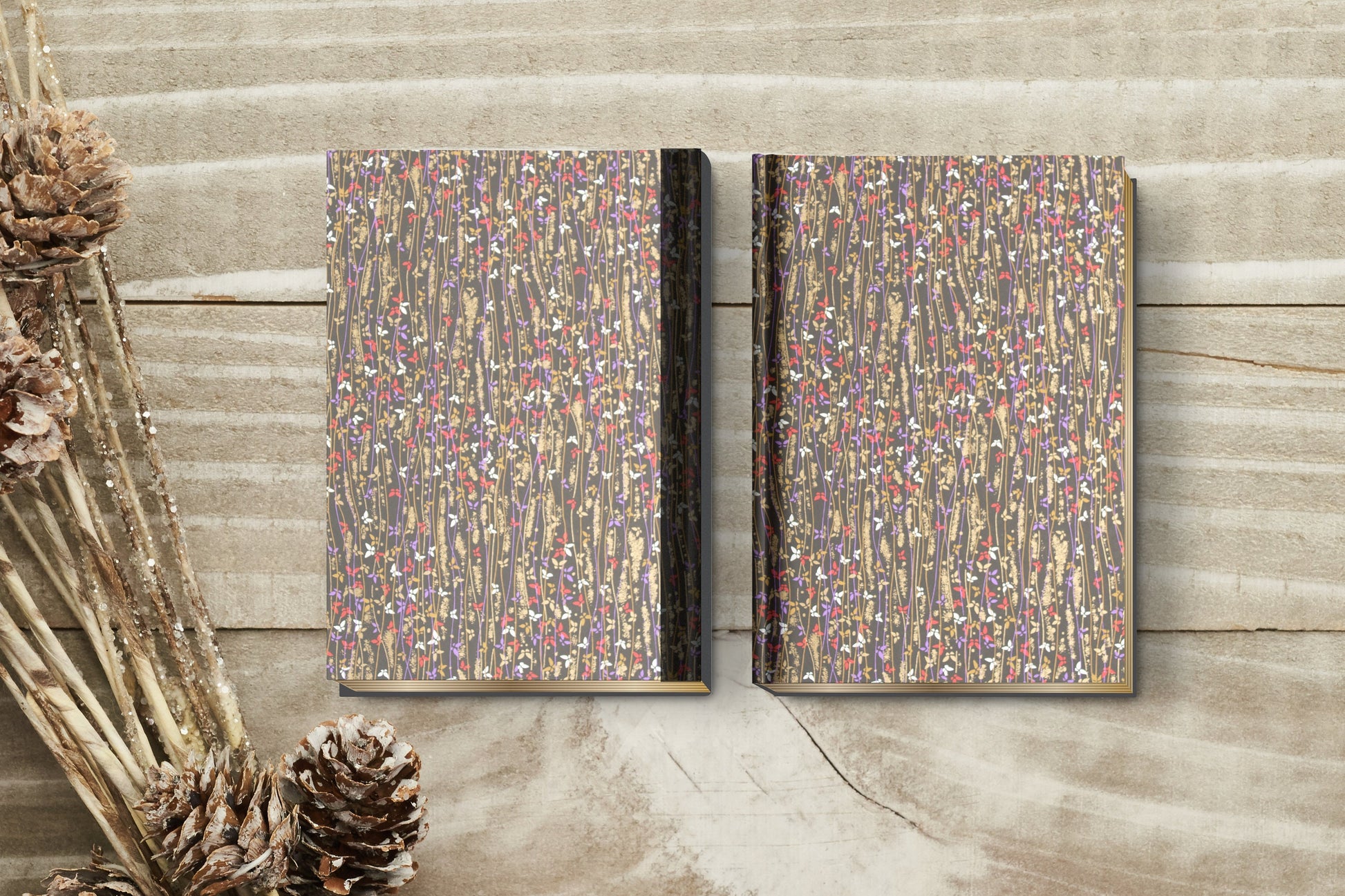 Two decorative books with a multicolored pattern on a wooden surface.
