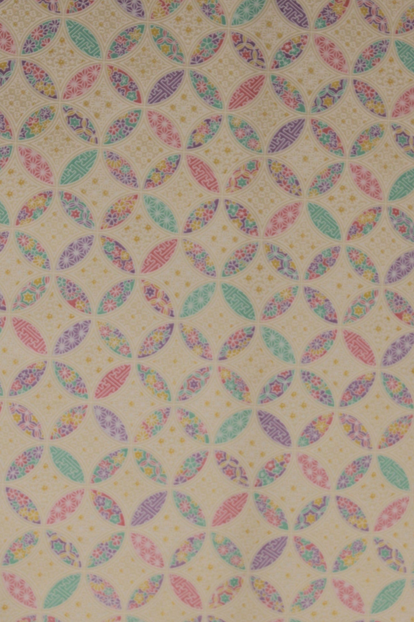 Patterned chiyogami paper with multicolored geometric design on a beige background