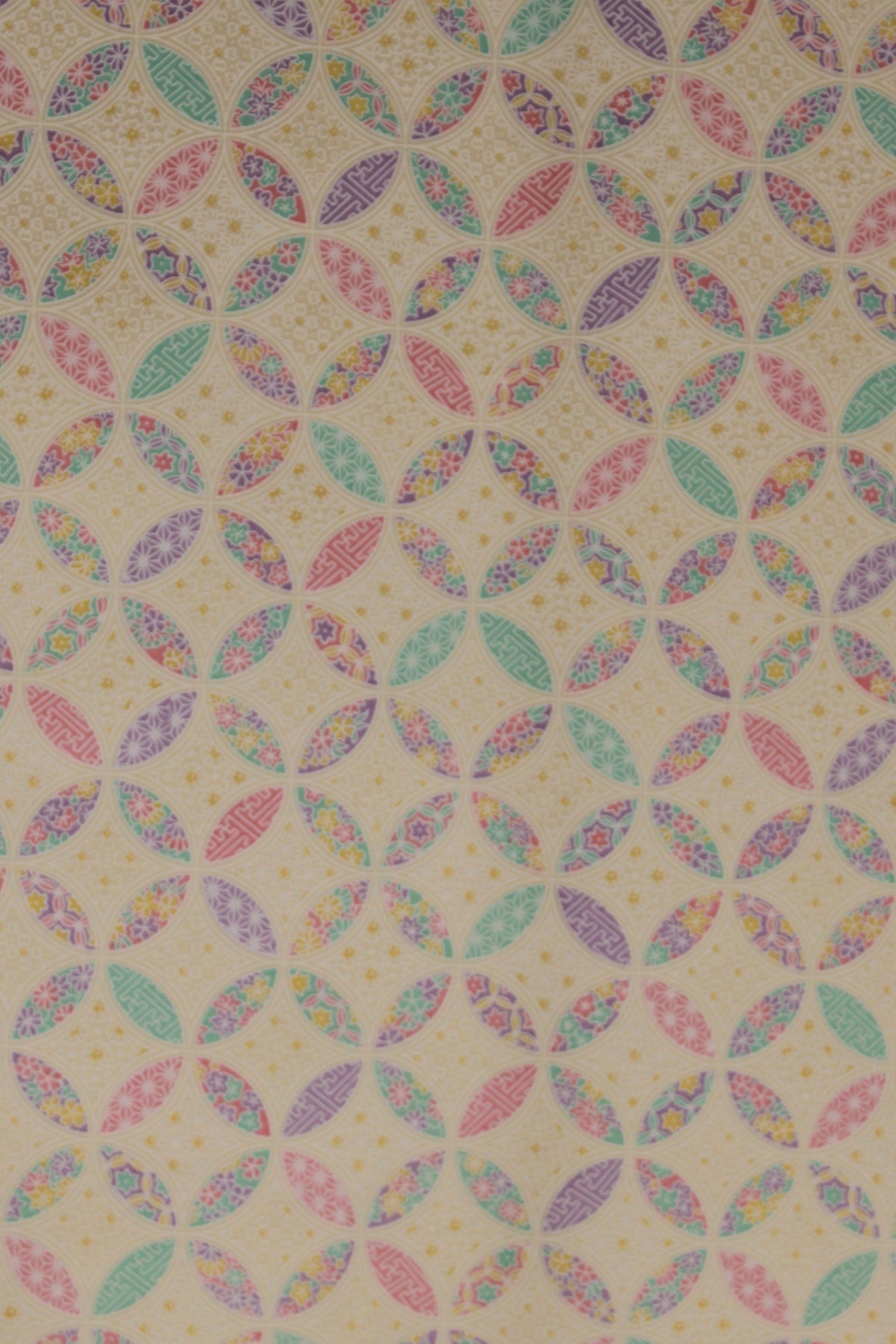 Patterned chiyogami paper with multicolored geometric design on a beige background