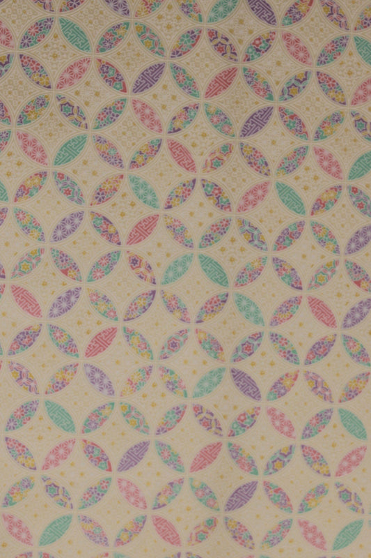 Patterned chiyogami paper with multicolored geometric design on a beige background